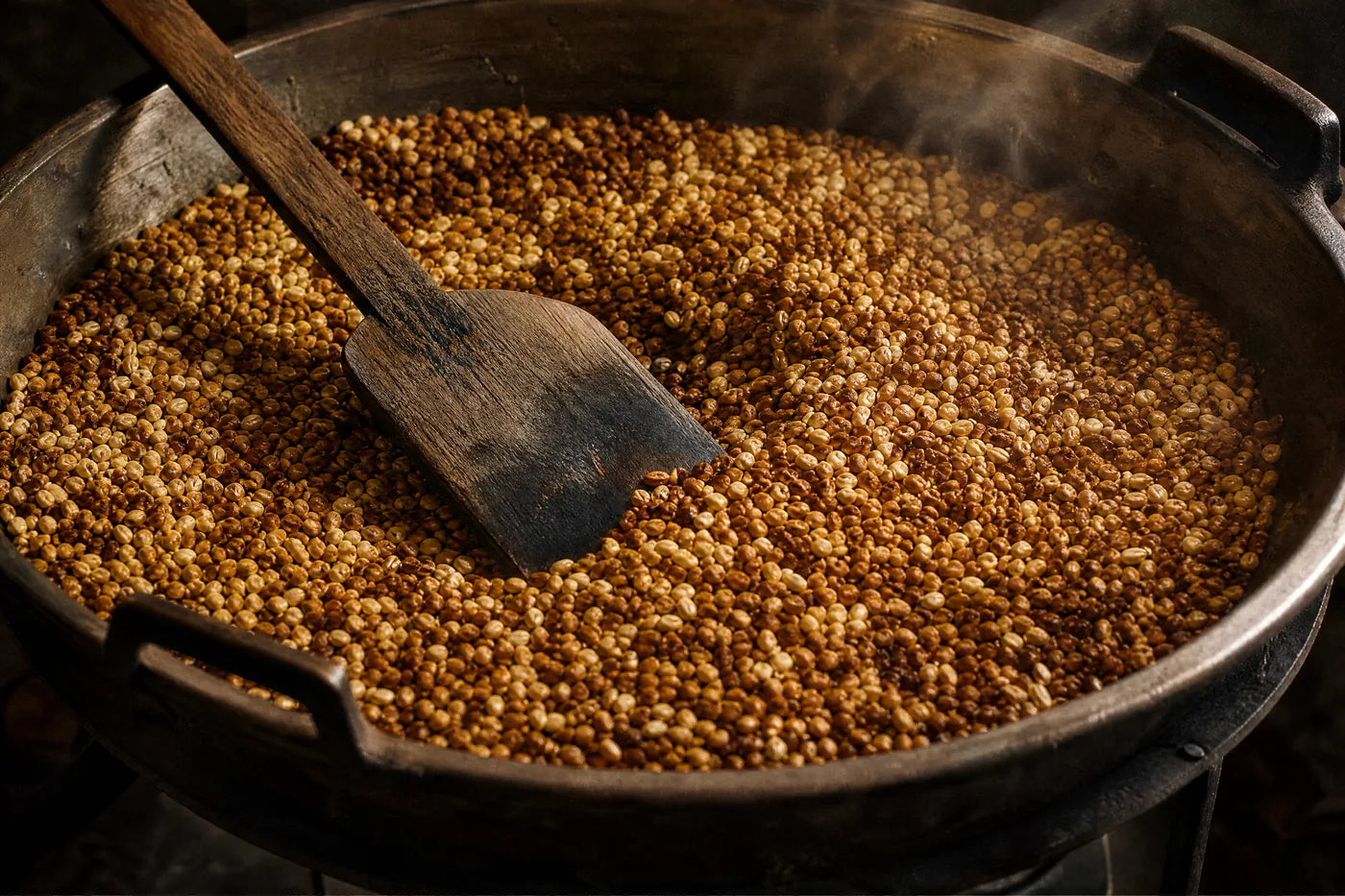 Grain part-way through roasting in a steel pan